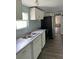 Modern kitchen with white cabinets and gray countertops at 11911 Rhodine Rd, Riverview, FL 33579