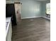 Open living area with wood-look floors and access to kitchen at 11911 Rhodine Rd, Riverview, FL 33579
