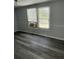 Spacious bedroom with large windows and wood-look floors at 11911 Rhodine Rd, Riverview, FL 33579