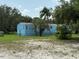 Single-wide mobile home with a blue exterior and deck at 11911 Rhodine Rd, Riverview, FL 33579