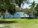 Single-wide mobile home with a blue exterior and deck at 11911 Rhodine Rd, Riverview, FL 33579