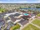 Aerial view of community center, pool, shuffleboard, bocce ball and lake nearby at 1321 Bluewater Dr, Sun City Center, FL 33573