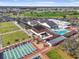 Stunning aerial view of community center, pool, shuffleboard, and bocce ball court at 1321 Bluewater Dr, Sun City Center, FL 33573