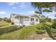 View of the backyard and screened in porch with a grill at 1321 Bluewater Dr, Sun City Center, FL 33573