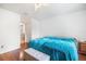Bedroom with wood-look floors and two beds, featuring view into the bathroom at 1321 Bluewater Dr, Sun City Center, FL 33573