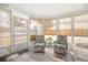 Light-filled sunroom featuring two sitting chairs and lots of light at 1321 Bluewater Dr, Sun City Center, FL 33573