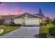 Charming single-story home featuring a stone-accented facade and a well-manicured lawn at 1321 Bluewater Dr, Sun City Center, FL 33573