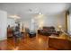 Spacious living room with wood floors, comfortable seating, and ample natural light at 1321 Bluewater Dr, Sun City Center, FL 33573