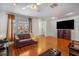 Bright living room showcasing wood floors, a comfortable sofa, and a large window at 1321 Bluewater Dr, Sun City Center, FL 33573