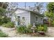 Gray house with teal door and well-manicured landscaping at 155 12Th Ne Ave, St Petersburg, FL 33701