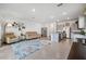 Open concept living and kitchen area with gray cabinets and granite countertops at 16701 Maude Dr, Wimauma, FL 33598