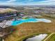 Aerial view of a resort-style community with a large lagoon pool at 16701 Maude Dr, Wimauma, FL 33598