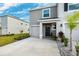 Townhome with gray exterior, two-car garage, and front landscaping at 16701 Maude Dr, Wimauma, FL 33598