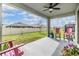 Covered patio with pink chairs and a view of the backyard at 31603 Magna Gulf Loop, San Antonio, FL 33576