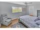 Serene bedroom with gray bed, wood floors, and an area rug at 6994 Country Lakes Cir, Sarasota, FL 34243