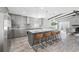 Modern kitchen with gray cabinets, granite countertops, and island seating at 7343 Brookview Cir, Tampa, FL 33634