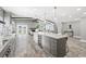 Open concept kitchen with large island, gray cabinets and granite countertops at 7343 Brookview Cir, Tampa, FL 33634