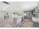 Open concept kitchen with island, gray cabinets, and granite countertops at 7343 Brookview Cir, Tampa, FL 33634