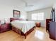 Bright bedroom featuring a king-size bed and wood flooring at 7701 Starkey Rd # 324, Seminole, FL 33777