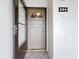 Exterior condo entrance with brown door and glass storm door at 7701 Starkey Rd # 324, Seminole, FL 33777