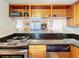 Modern kitchen with stainless steel appliances and open pass-through to living area at 7701 Starkey Rd # 324, Seminole, FL 33777