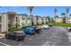 Condo building with parking lot and tropical landscaping at 7701 Starkey Rd # 324, Seminole, FL 33777
