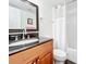 Bathroom with wood vanity, granite countertop, and a shower/tub combo at 7701 Starkey Rd # 324, Seminole, FL 33777