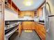 Modern kitchen with wood cabinets, granite countertop, and stainless steel appliances at 7701 Starkey Rd # 324, Seminole, FL 33777