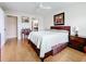 Comfortable bedroom with a king bed, hardwood floors, and access to the bathroom at 7701 Starkey Rd # 324, Seminole, FL 33777