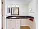 Bathroom features granite countertop, white cabinets, and a large mirror at 7701 Starkey Rd # 324, Seminole, FL 33777