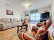 Comfortable living room with hardwood floors and access to a balcony at 7701 Starkey Rd # 324, Seminole, FL 33777
