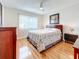 Main bedroom with a queen bed and wood floors at 7701 Starkey Rd # 324, Seminole, FL 33777
