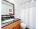 Bathroom with wood vanity, granite countertop, and a shower/tub combo at 7701 Starkey Rd # 324, Seminole, FL 33777