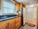 Clean kitchen featuring wood cabinets, granite countertops, and a window at 7701 Starkey Rd # 324, Seminole, FL 33777