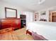 King-size bed, dresser, and wood floors in this relaxing bedroom at 7701 Starkey Rd # 324, Seminole, FL 33777