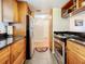 Bright kitchen with stainless steel appliances and wood cabinets at 7701 Starkey Rd # 324, Seminole, FL 33777