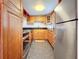 Modern kitchen with wood cabinets and stainless steel appliances at 7701 Starkey Rd # 324, Seminole, FL 33777