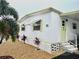 Inviting exterior with a well-maintained yard and stone pathway at 9790 66Th N St # 208, Pinellas Park, FL 33782