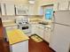 Cozy kitchen featuring white cabinets, modern appliances, and a breakfast bar at 9790 66Th N St # 208, Pinellas Park, FL 33782