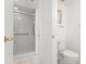 Bathroom with walk-in shower, white tile, and toilet at 11485 Oakhurst Rd # 322, Largo, FL 33774