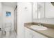 Bathroom featuring a white sink, mirror, toilet, and shower at 11485 Oakhurst Rd # 322, Largo, FL 33774