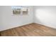 Neutral bedroom with a window providing natural light and wood flooring at 11485 Oakhurst Rd # 322, Largo, FL 33774