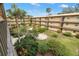View of the building's courtyard with lush landscaping and seating area at 11485 Oakhurst Rd # 322, Largo, FL 33774