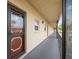 Exterior hallway entrance featuring the unit's front door and an open-air corridor to other units at 11485 Oakhurst Rd # 322, Largo, FL 33774