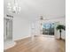 Inviting living room with wood floors, ceiling fan, and sliding glass doors opening to a covered balcony at 11485 Oakhurst Rd # 322, Largo, FL 33774