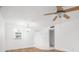 Bright living room with wood floors, ceiling fan and chandelier, enhanced by a nearby window at 11485 Oakhurst Rd # 322, Largo, FL 33774