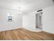 Sun-filled living room with wood floors, chandelier, and a nearby window, providing a bright living space at 11485 Oakhurst Rd # 322, Largo, FL 33774