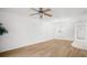 Spacious living room with wood floors, ceiling fan and chandelier, offering an airy and inviting atmosphere at 11485 Oakhurst Rd # 322, Largo, FL 33774