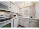 White kitchen with ample cabinetry, microwave, oven, and dishwasher at 1200 N Shore Ne Dr # 216, St Petersburg, FL 33701