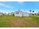 Spacious backyard with grassy area behind the home at 122 E Saint Johns Way, Apollo Beach, FL 33572